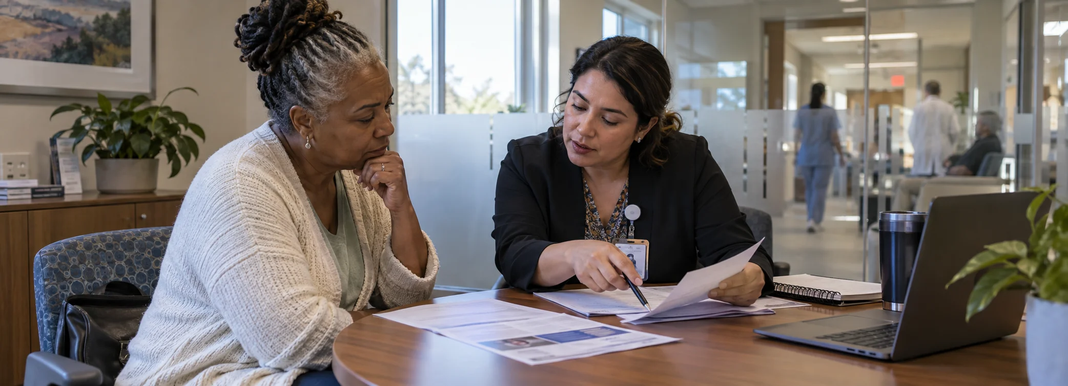 Clinical patient advocate and case navigator reviewing diagnostic history and medical records with patient.